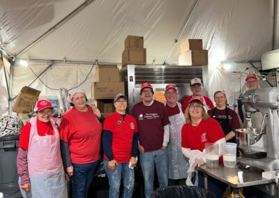 Several individuals in matching red aprons and hats, likely part of a team or group event.