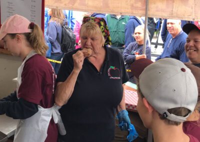 A lady in a maroon shirt posing for a photo.