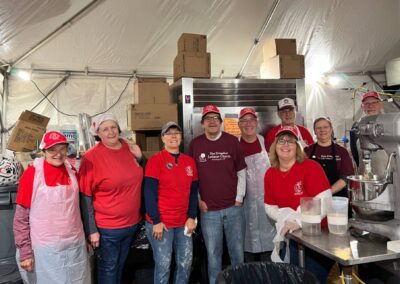 Several individuals in matching red aprons and hats, likely part of a team or group event.